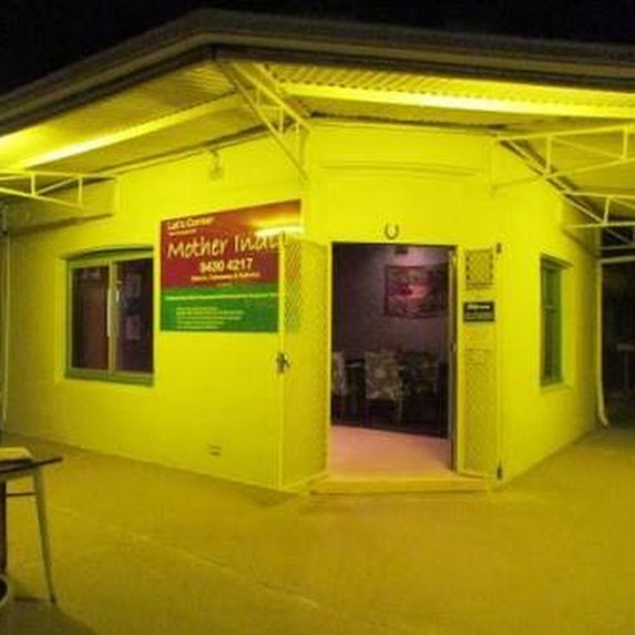 Mother India Fremantle welcoming yellow storefront at night